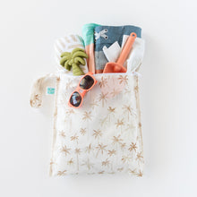 Load image into Gallery viewer, Bumkins Wet Bag: Palm Daze keeps sunglasses, toy palm tree, trunks, spade &amp; towel dry with waterproof protection on a white background.
