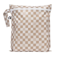 Load image into Gallery viewer, Roamio by Bumkins Wet Bag: Sand Check is a tan checkered waterproof bag with zipper closure and side handle.
