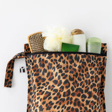 Load image into Gallery viewer, Roamio by Bumkins Wet Bag: Leopard filled with toiletries lays on a white background.
