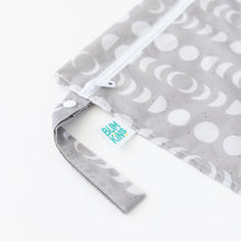 Load image into Gallery viewer, Close-up of Bumkins Wet Bag: Lunar Phase on a white background, showcasing the side strap and logo label.
