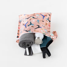Load image into Gallery viewer, Bumkins Wet Bag: Yoga Pals holds a gray towel, water bottle, gym clothes, and small items effortlessly on a white background.
