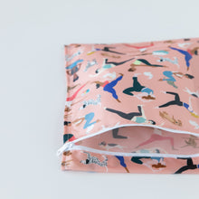 Load image into Gallery viewer, Bumkins Wet Bag: Yoga Pals lays partially open on a white background, revealing the interior.
