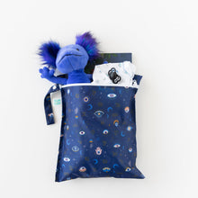 Load image into Gallery viewer, Bumkins Wet Bag: Evil Eye holds a plush toy, clothes, a book, and a pacifier on a white background.
