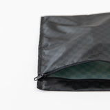 Roamio by Bumkins Wet Bag: Rich Black lays partially open on a white background, revealing the interior.
