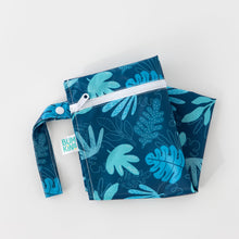 Load image into Gallery viewer, Bumkins Wet Bag: Blue Tropic lays folded on a white background.
