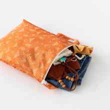 Load image into Gallery viewer, Bumkins Wet Bag: Grounded lays open on a white background with clothes and swimwear peeking out.
