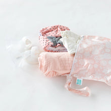 Load image into Gallery viewer, Bumkins Wet Bag: Lace lays on a white background, with a nursing cover, cloth diapers, &amp; breast pump parts spilling out.
