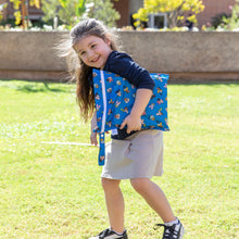 Load image into Gallery viewer, A smiling girl outdoors on grass carries a Bumkins Wet Bag: Mickey &amp; Friends Forever.
