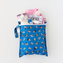 Load image into Gallery viewer, Bumkins Wet Bag: Mickey &amp; Friends Forever lays on a white background holding a unicorn toy, pink sunglasses, and a book.
