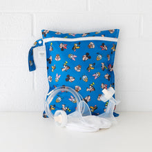 Load image into Gallery viewer, Bumkins Wet Bag: Mickey &amp; Friends Forever sits against a white brick wall with breast pump parts in front.

