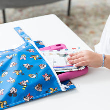 Load image into Gallery viewer, A child's hand pulls a pink tablet a the Bumkins Wet Bag: Mickey &amp; Friends Forever on a white table.
