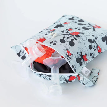 A partially open Bumkins Wet Bag: Mickey Mouse Classic holds breast pump parts and cloth diapers on a white background.