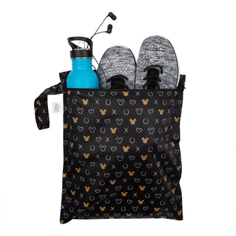 Bumkins Wet Bag: Minnie Mouse Icon Black + White holds gray sneakers, wired earbuds, and a blue water bottle on a white background.