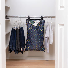 Load image into Gallery viewer, Bumkins Extra Large Wet Bag: Super Mario™ Lineup hangs in a closet next to pants and shirts on hangers.
