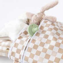 Load image into Gallery viewer, Close-up of a plush bunny and green pacifier in a chic Bumkins Wet/Dry Bag: Sand Check, crafted from waterproof fabric, on a white background.
