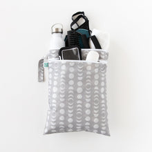 Load image into Gallery viewer, Bumkins Wet/Dry Bag: Lunar Phase holds gym essentials like a bottle, phone, towel, clothes and toiletries on a white background.
