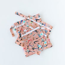 Load image into Gallery viewer, Bumkins Wet/Dry Bag: Yoga Pals lays flat on a white background underneath similar bags with matching patterns.
