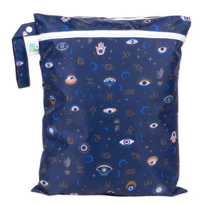 Bumkins Wet/Dry Bag: Evil Eye features celestial prints with eyes, stars, moons, and zodiac signs on dark blue waterproof fabric.