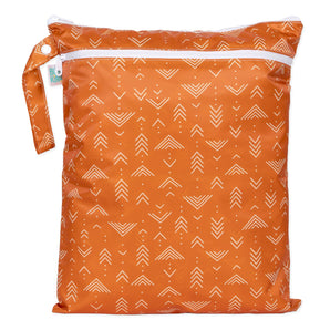 Bumkins Wet/Dry Bag: Grounded features white arrows on orange waterproof fabric, two zippered compartments, and a side handle.