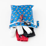 Bumkins Wet/Dry Bag: Mickey & Friends Forever is shown open on a white background with red sunglasses, white sneakers, and clothes inside.