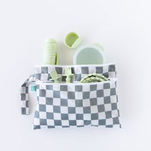 Load image into Gallery viewer, Bumkins Wet/Dry Clutch: Charcoal Check holds a cup, spoon, fork, and bottle in green on a white background.
