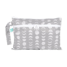 Load image into Gallery viewer, Bumkins Wet/Dry Clutch: Lunar Phase—a waterproof gray pouch with a white moon phase pattern, small wrist strap, and Bumkins logo tag.
