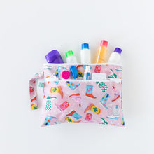Load image into Gallery viewer, Bumkins Wet/Dry Clutch: Boots holds travel-sized bottles &amp; containers on a white background.
