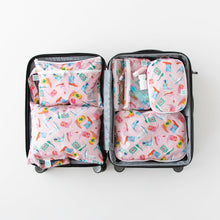 Load image into Gallery viewer, An open suitcase on a white background with Bumkins Wet/Dry Clutch: Boots inside next to other matching bags.
