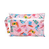Bumkins Wet/Dry Clutch: Boots features cowboy boot patterns on pink, waterproof fabric, with a zip closure & side strap.