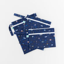 Load image into Gallery viewer, Bumkins Wet/Dry Clutch: Evil Eye is arranged on top of other similar bags in a fan shape on a white background.
