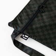Load image into Gallery viewer, Close-up of Roamio by Bumkins Wet/Dry Clutch: Rich Black on a white background with focus on the side handle and logo tag.
