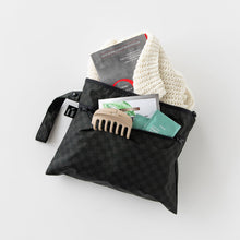 Load image into Gallery viewer, Roamio by Bumkins Wet/Dry Clutch: Rich Black holds a book, hair clip, sweater, and tea bags on a white background.
