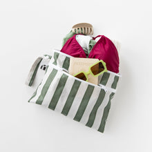 Load image into Gallery viewer, Roamio by Bumkins Wet/Dry Clutch: Clubhouse Stripe with swimwear, sunglasses, hair clip &amp; passport on a white background.
