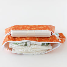Load image into Gallery viewer, Bumkins Wet/Dry Clutch: Grounded lays open on a white background, holding wipes, diapers, and clothes.
