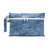 Roamio by Bumkins Wet/Dry Clutch: Crushed Denim is a zippered pouch with two compartments made of blue denim printed waterproof fabric.