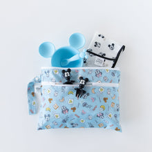 Load image into Gallery viewer, Bumkins Wet/Dry Clutch: Mickey + Minnie Sunny Side Up holds a patterned bib, a blue bowl and spoon, and Mickey utensils on a white background.
