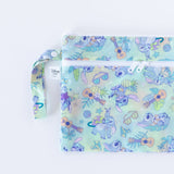 Bumkins Wet/Dry Clutch: Aloha Stitch is half visible as it lays flat on a white background.