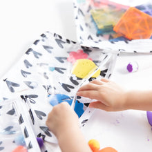 Load image into Gallery viewer, Close-up of a child reaching into a Bumkins Clear Travel Bag 3-Pack: Hearts  filled with craft supplies.
