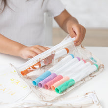 Load image into Gallery viewer, A child organizing colorful markers in a Bumkins Clear Travel Bag 3 Pack: Palm Daze on a white table.
