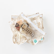 Load image into Gallery viewer, Bumkins Clear Travel Bag 3 Pack: Palm Daze sits stacked on a white background, neatly holding small items like clips and hair ties.
