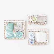 Load image into Gallery viewer, Roamio by Bumkins Clear Travel Bag 3 Pack: Sand Check is neatly arranged on a white background with toiletries inside.
