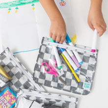Load image into Gallery viewer, A child removes markers from a Bumkins Clear Travel Bag 3 Pack: Charcoal Check at a white table.
