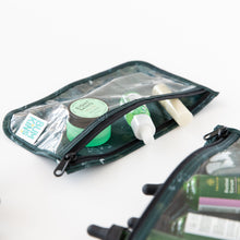 Load image into Gallery viewer, Close-up of Bumkins Clear Travel Bag 3 Pack: Starry Cactus filled with green &amp; white skincare items on white background.
