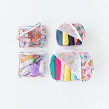 Load image into Gallery viewer, Bumkins Clear Travel Bag 3 Pack: Boots, filled with toiletries and cosmetics, sits next to organizers filled with clothes on a white background.
