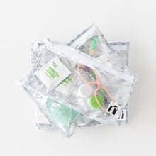 Load image into Gallery viewer, Roamio by Bumkins Clear Travel Bag 3 Pack: Disco Check is stacked on a white background, with glasses, a contact lens case, &amp; toiletries.
