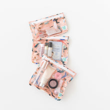 Load image into Gallery viewer, Bumkins Clear Travel Bag 3 Pack: Yoga Pals packed with toiletries is arranged vertically on a white background.
