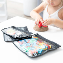 Load image into Gallery viewer, A child plays with kinetic sand at a white table with toys in Bumkins Clear Travel Bag 3 Pack: Rich Black nearby.
