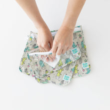 Load image into Gallery viewer, Hands use a cloth to clean the interior of Bumkins Clear Travel Bag 3-Pack: Cacti on a white background.
