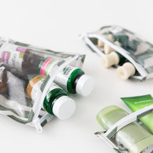 Load image into Gallery viewer, Close-up of Roamio by Bumkins Clear Travel Bag 3 Pack: Clubhouse Stripe with vitamins and toiletries on a white background.
