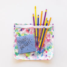 Load image into Gallery viewer, Vibrant pencils peek from a Bumkins Clear Travel Bag 3-Pack: Watercolor on a white background, with a blue note stating “Shine Bright” inside.
